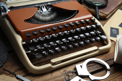 Photo of Typewriter on wooden table, closeup. Detective's workplace