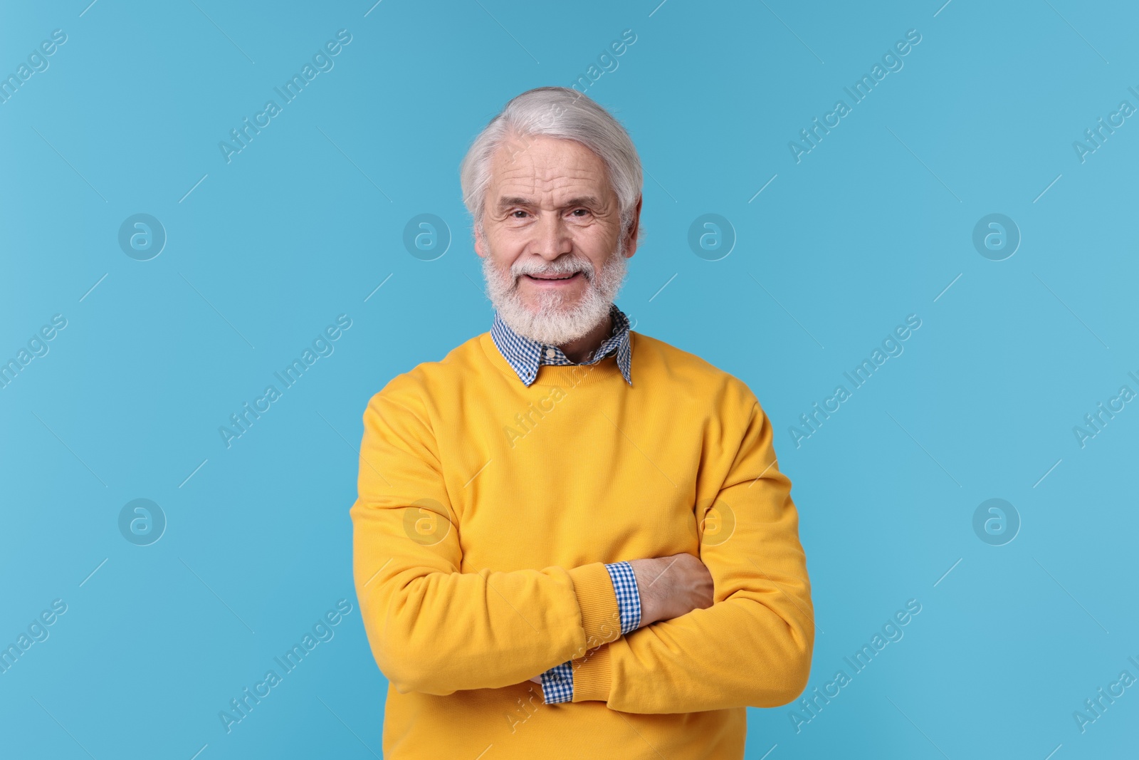 Photo of Portrait of stylish grandpa on light blue background