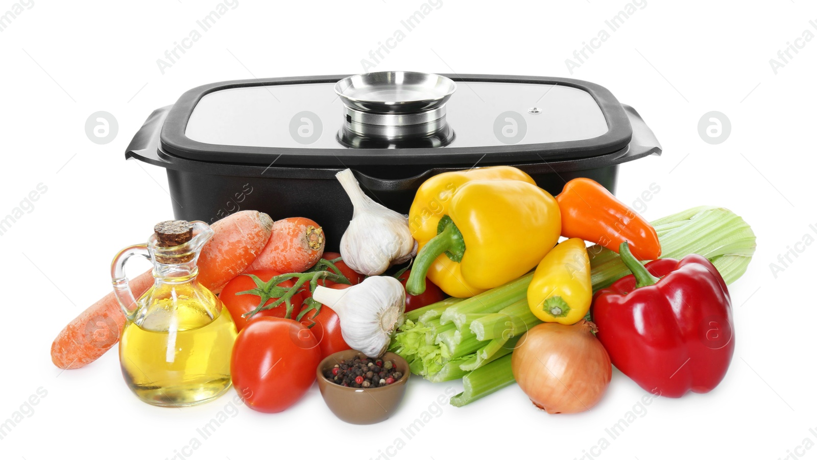 Photo of Black pot with glass lid and pile of fresh products isolated on white