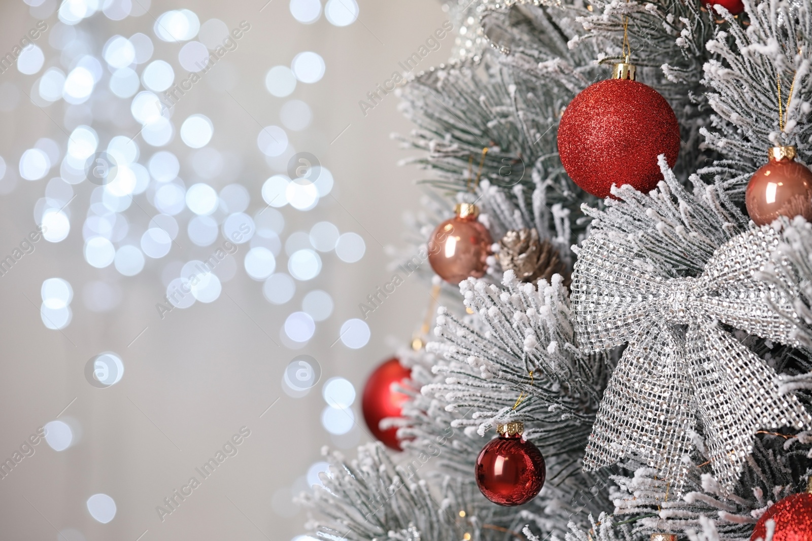 Photo of Beautiful Christmas tree with festive decor against blurred lights on background. Space for text