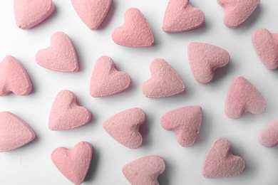 Photo of Flat lay composition with heart shaped candies on white background