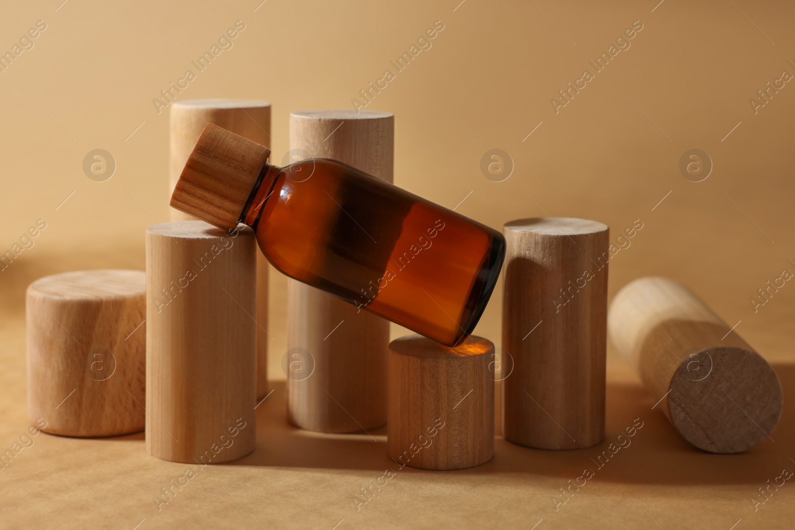 Photo of Composition with glass bottle of cosmetic product on dark beige background