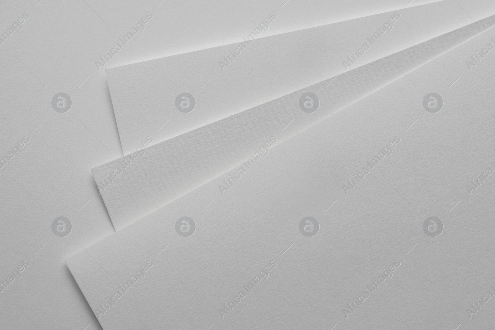 Photo of Blank watercolor paper sheets on white background, top view