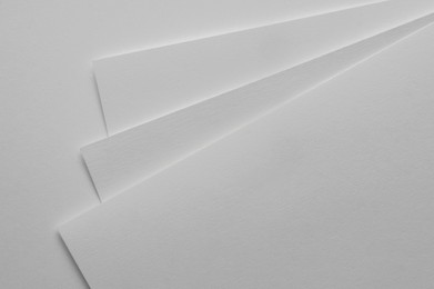 Photo of Blank watercolor paper sheets on white background, top view