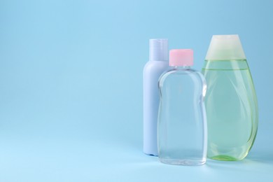 Photo of Different baby care products on light blue background, space for text