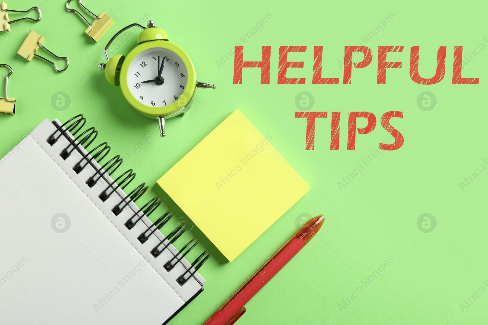 Image of Helpful Tips. Modern office accessorises on green background, flat lay