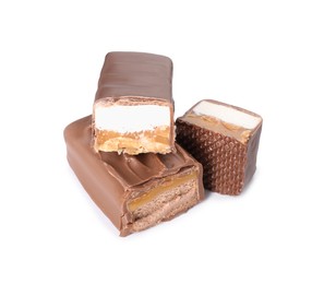 Photo of Pieces of tasty chocolate bars with nougat and nuts on white background