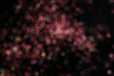 Photo of Color glitter on dark background. Bokeh effect
