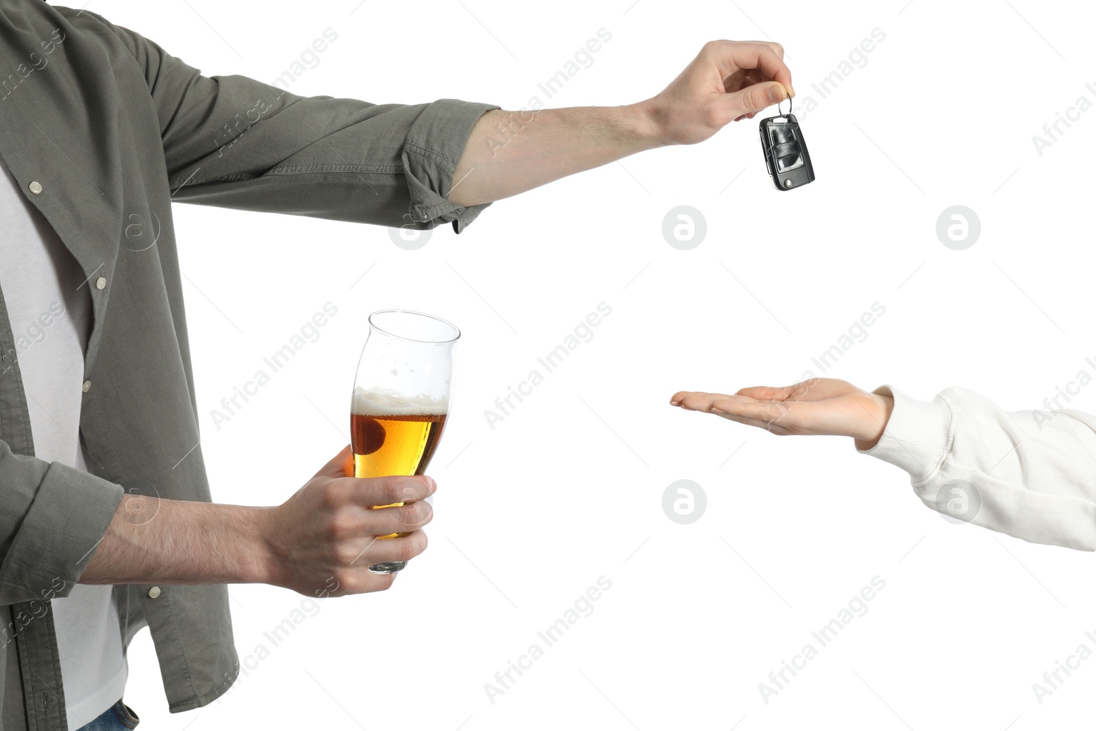 Photo of Man with glass of alcoholic drink giving car key to woman on white background, closeup. Don't drink and drive concept