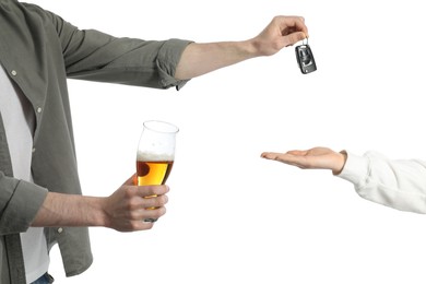 Man with glass of alcoholic drink giving car key to woman on white background, closeup. Don't drink and drive concept