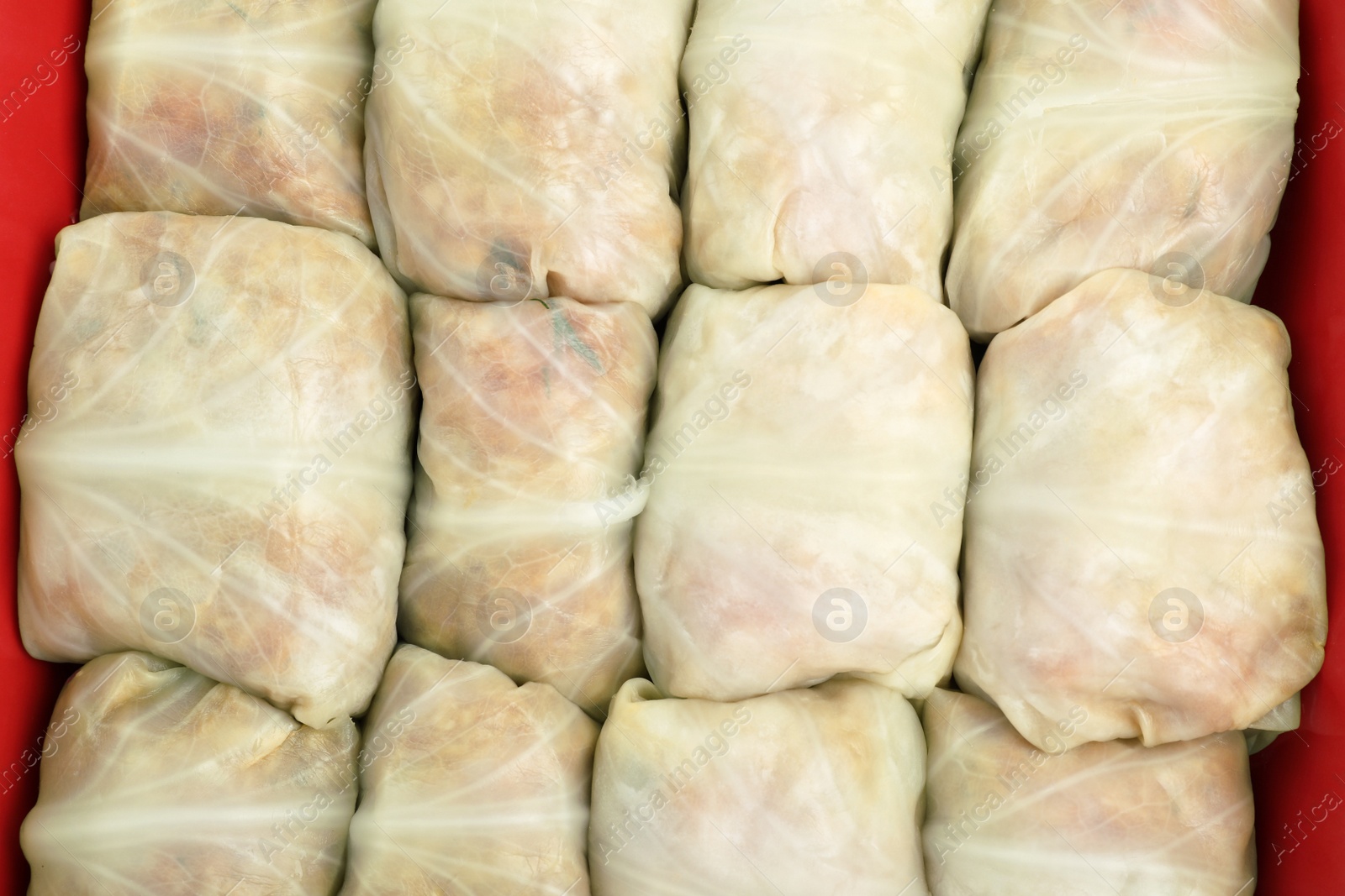 Photo of Stuffed cabbage rolls in baking dish as background, top view