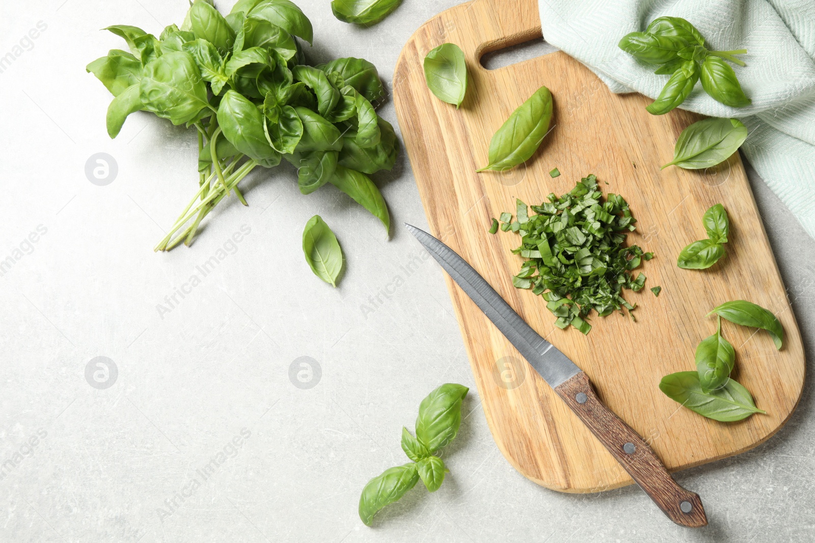 Photo of Fresh green basil on light grey table, flat lay