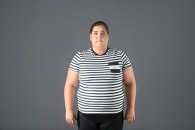 Photo of Portrait of overweight woman on gray background