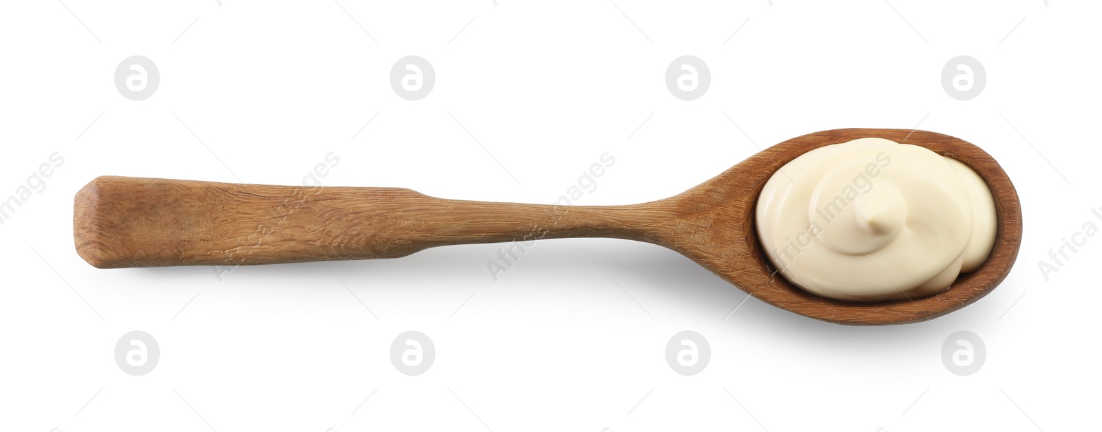 Photo of Natural yogurt in wooden spoon isolated on white, top view