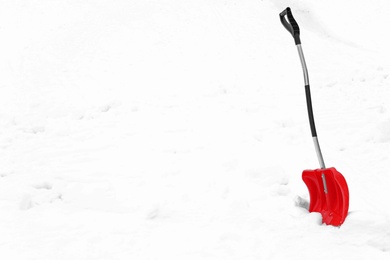 Photo of Shovel in snow, space for text. Winter outdoor work
