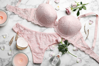 Photo of Flat lay composition with women's underwear on marble background