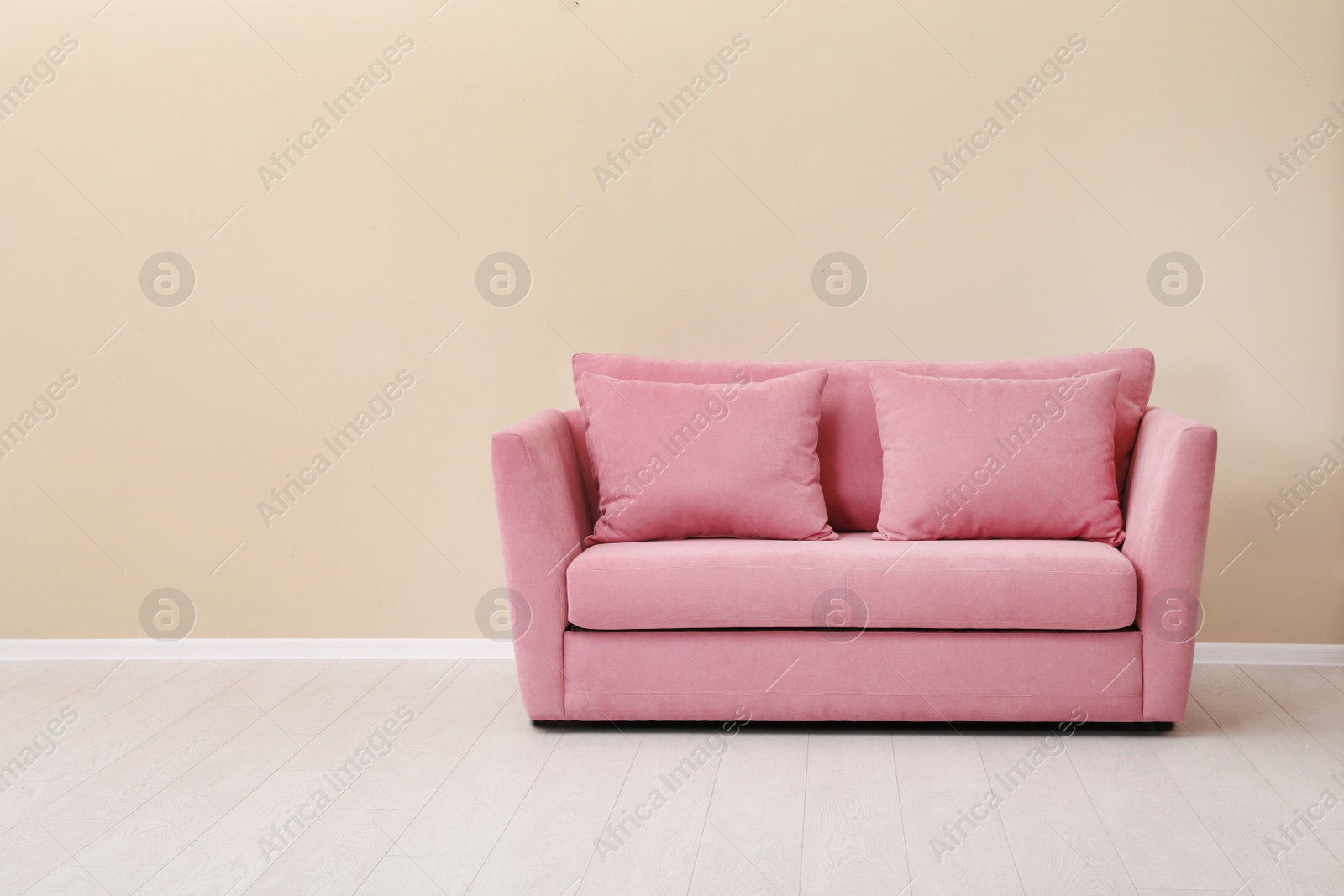 Photo of Room interior with comfortable sofa near color wall. Space for text
