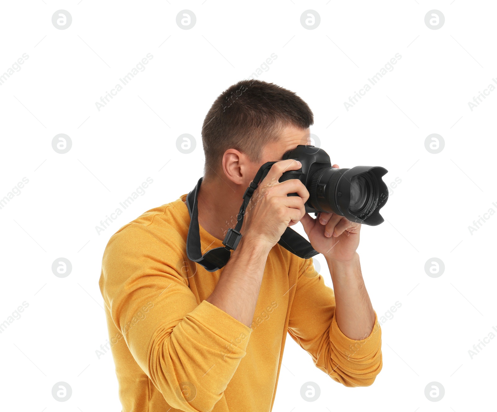 Photo of Young professional photographer taking picture on white background