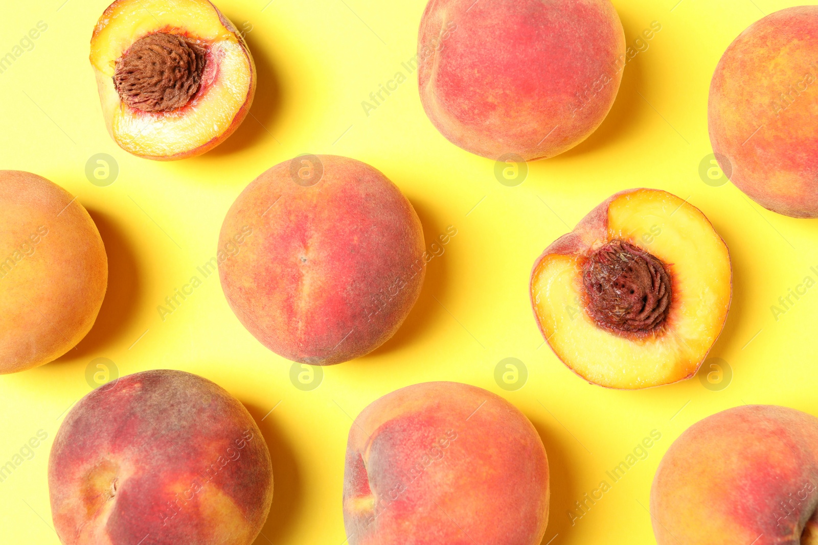 Photo of Delicious juicy peaches on yellow background, flat lay