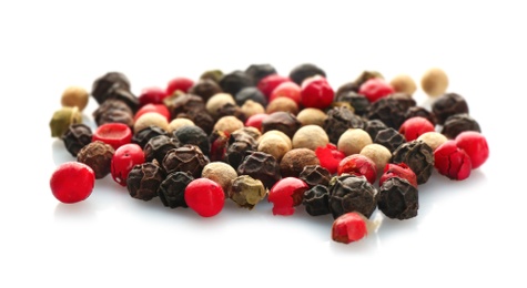 Mix of different pepper grains on white background