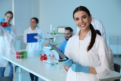 Photo of Medical student with clipboard in modern scientific laboratory