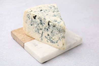 Piece of tasty blue cheese on light table