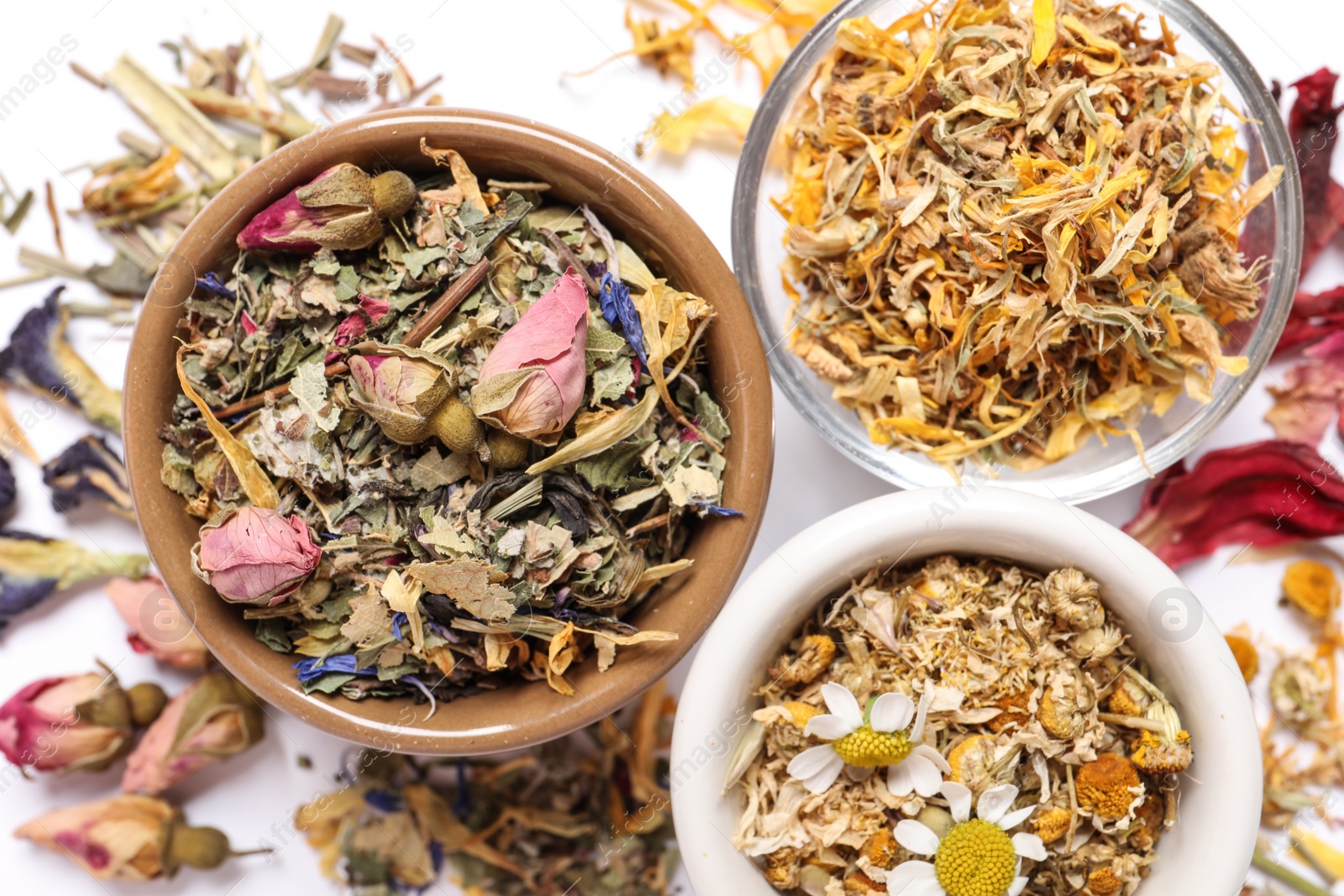 Photo of Different dry herbal teas on white background, flat lay