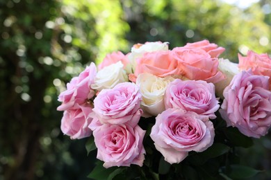 Photo of Beautiful bouquet of aromatic roses outdoors, closeup