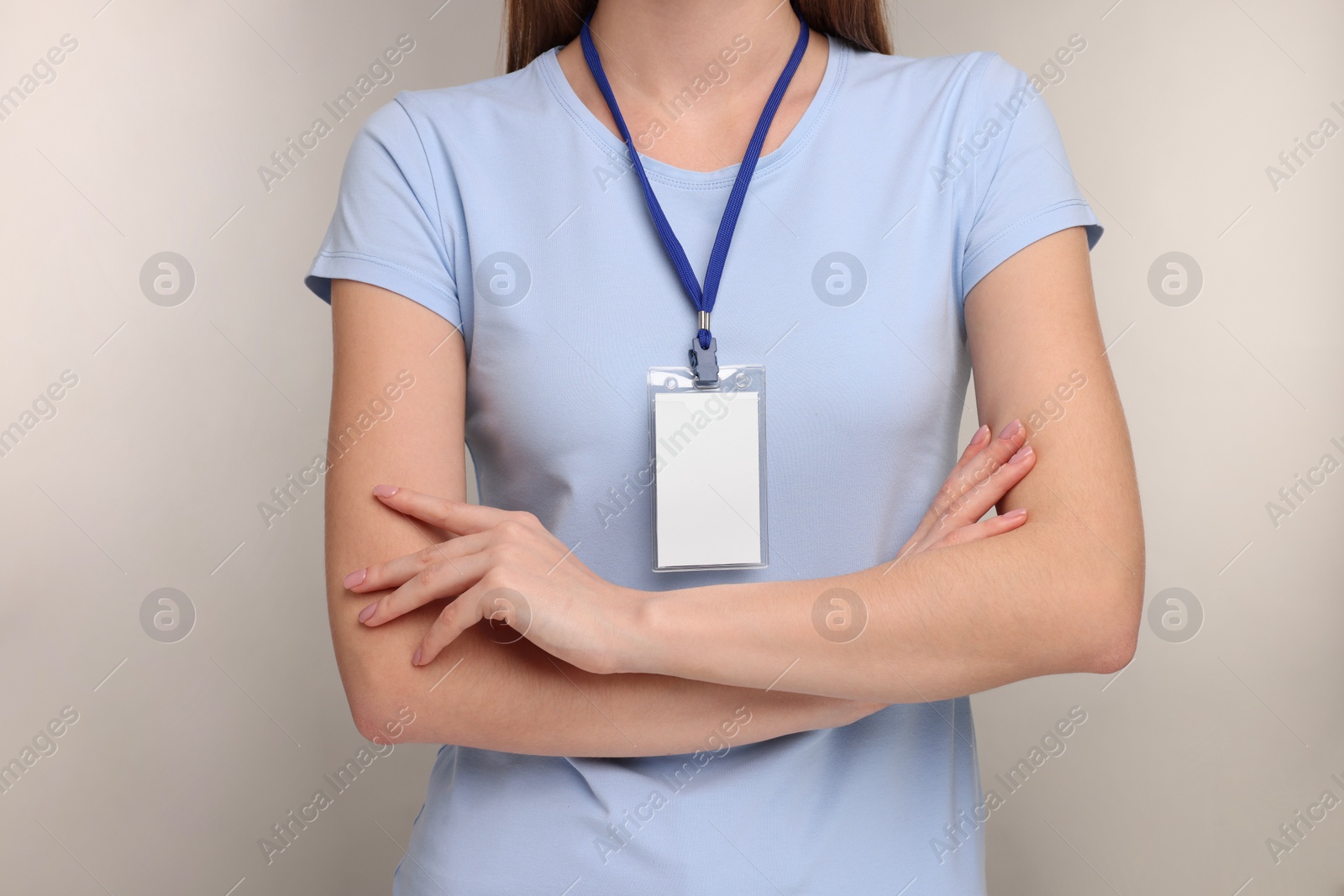 Photo of Woman with blank badge on grey background, closeup