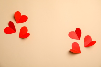 Small paper hearts on color background