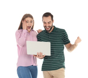 Emotional young people with laptop celebrating victory on white background