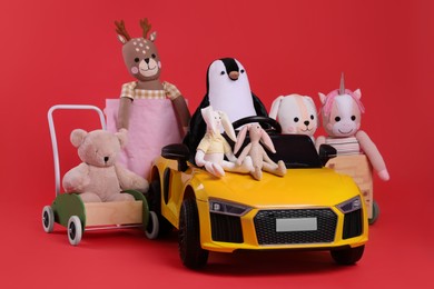 Photo of Child's electric car with other toys on red background