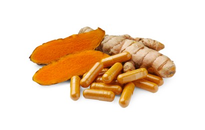 Photo of Aromatic turmeric roots and pills isolated on white