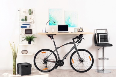 Modern home office interior with bicycle near wall