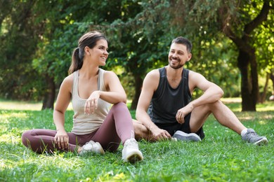 Photo of Man and woman resting after morning exercise in park