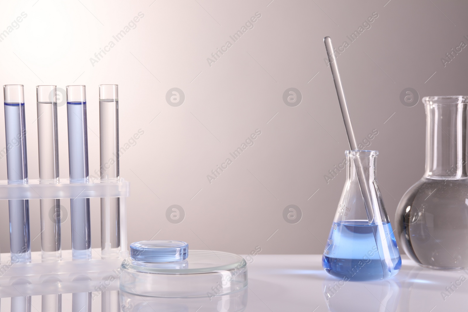 Photo of Laboratory analysis. Different glassware on table against light background