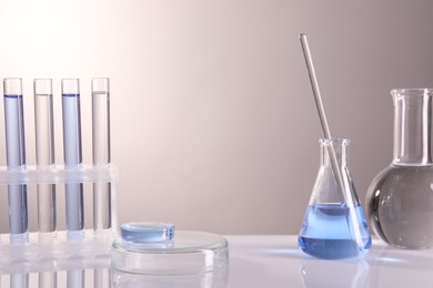 Laboratory analysis. Different glassware on table against light background