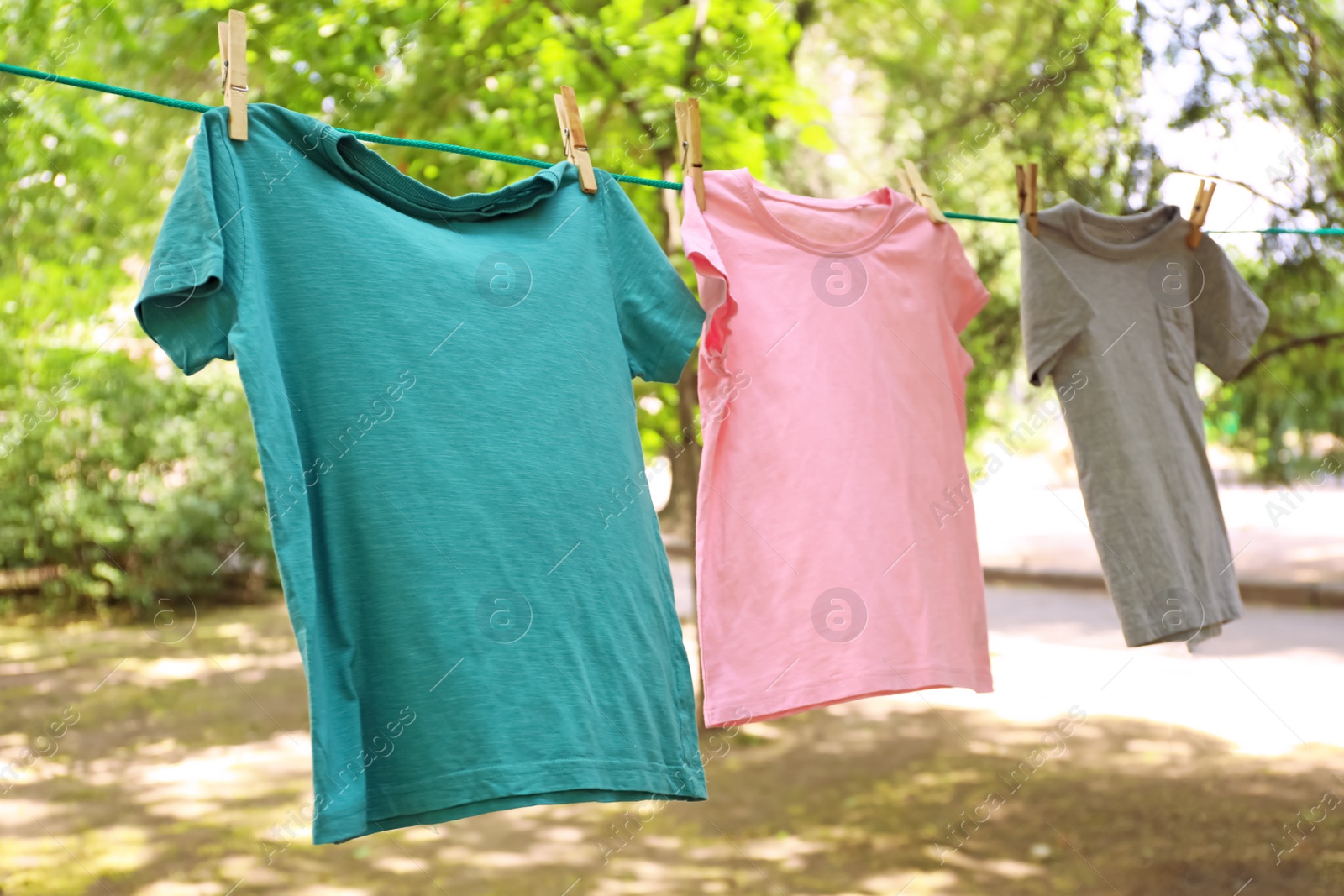 Photo of Laundry line with clothes outdoors on sunny day