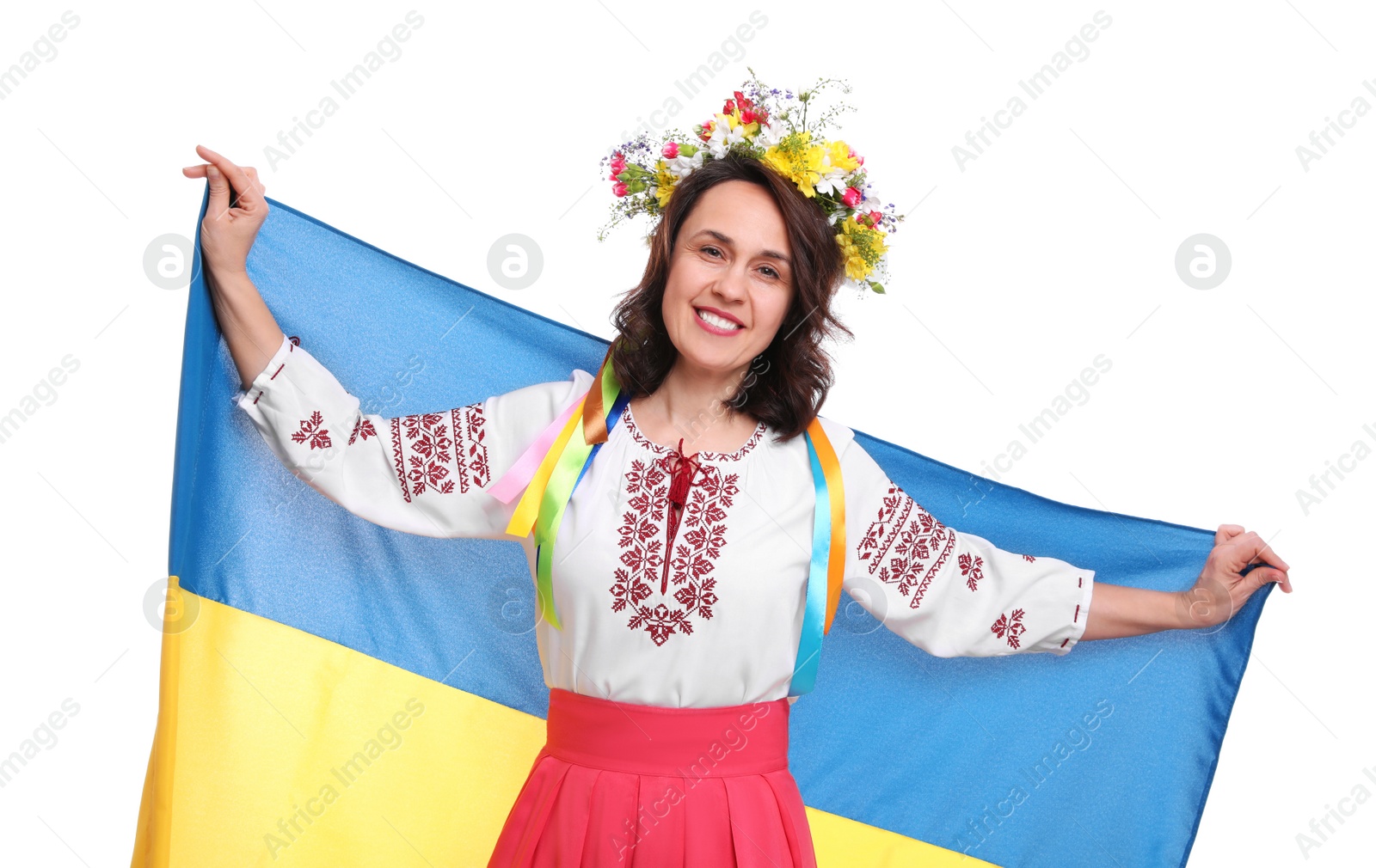 Photo of Happy woman in national clothes with flag of Ukraine on white background