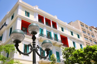 Photo of Old fashioned streetlight near building on sunny day