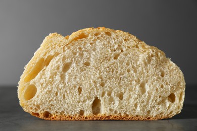 Freshly baked cut sourdough on grey table, closeup