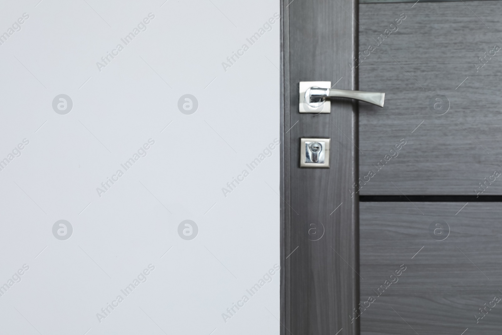 Photo of Dark wooden door in office, closeup. Space for text