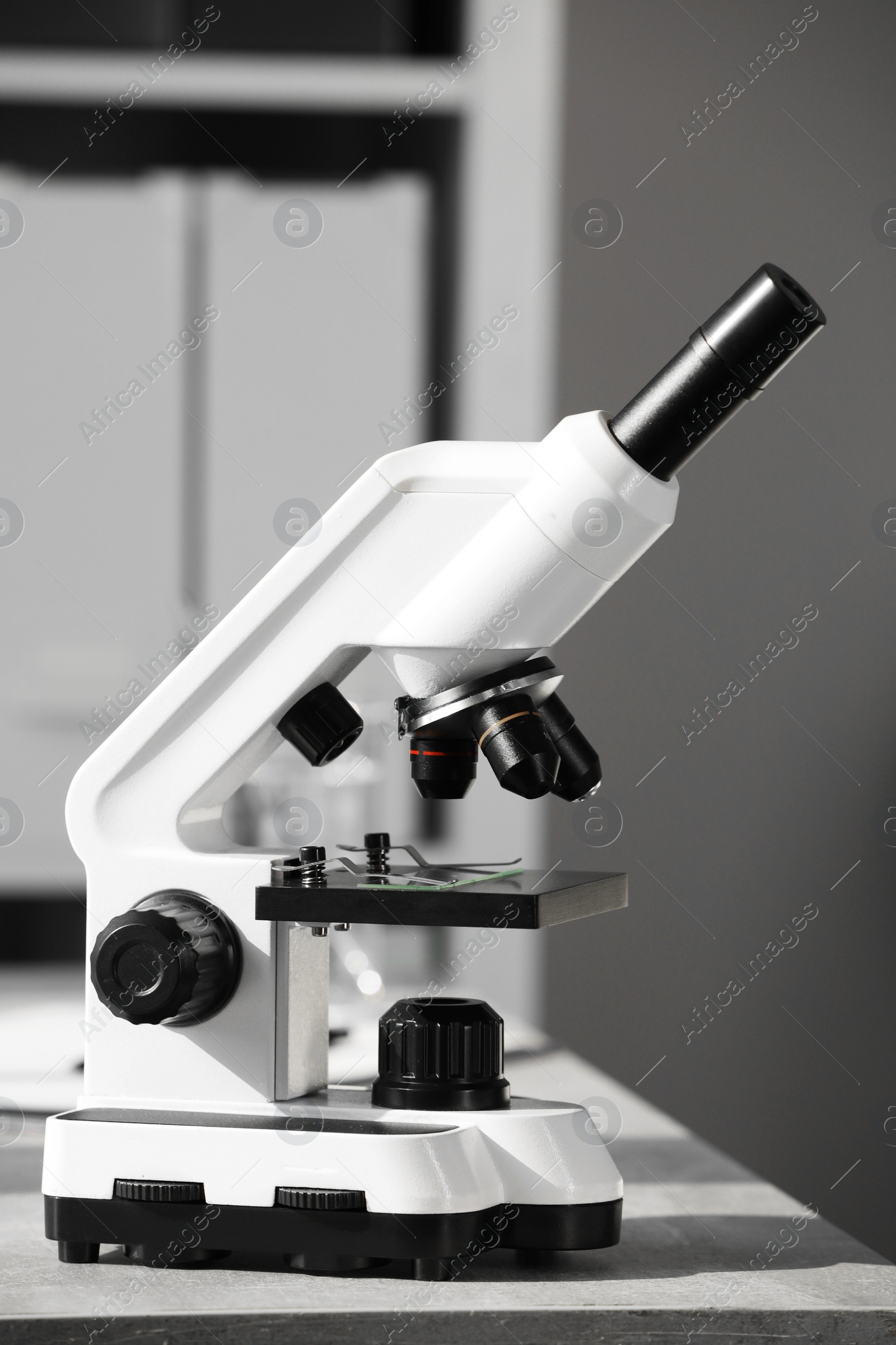 Photo of Modern medical microscope on table in laboratory