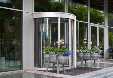 Photo of Potted flowers near entrance to beautiful modern building