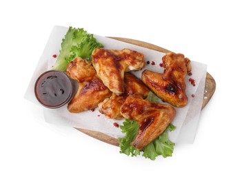 Photo of Board with marinade, chicken wings, spices and lettuce isolated on white, top view