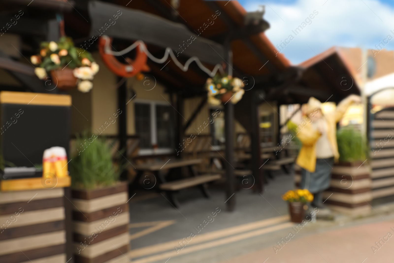 Photo of Blurred view of outdoor cafe with benches and tables