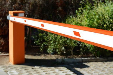 Modern road barrier outdoors on sunny day, closeup