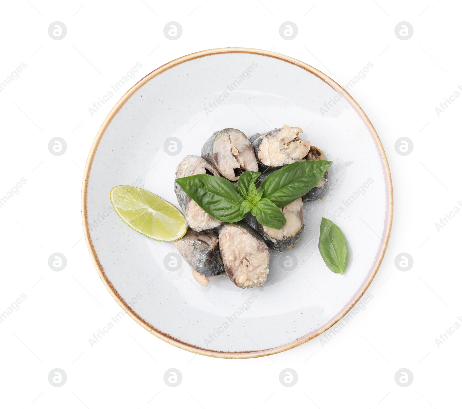 Photo of Plate with canned mackerel chunks, lime and basil isolated on white, top view