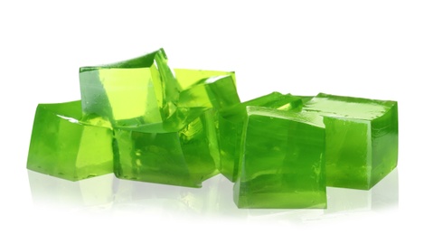 Photo of Heap of green jelly cubes on white background