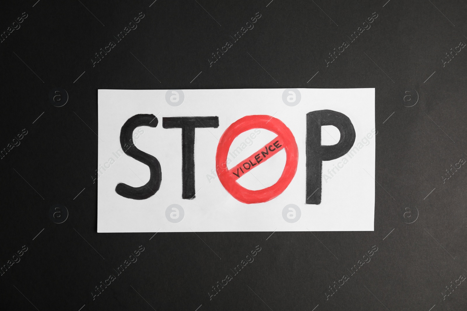 Photo of Phrase STOP VIOLENCE on black background, top view